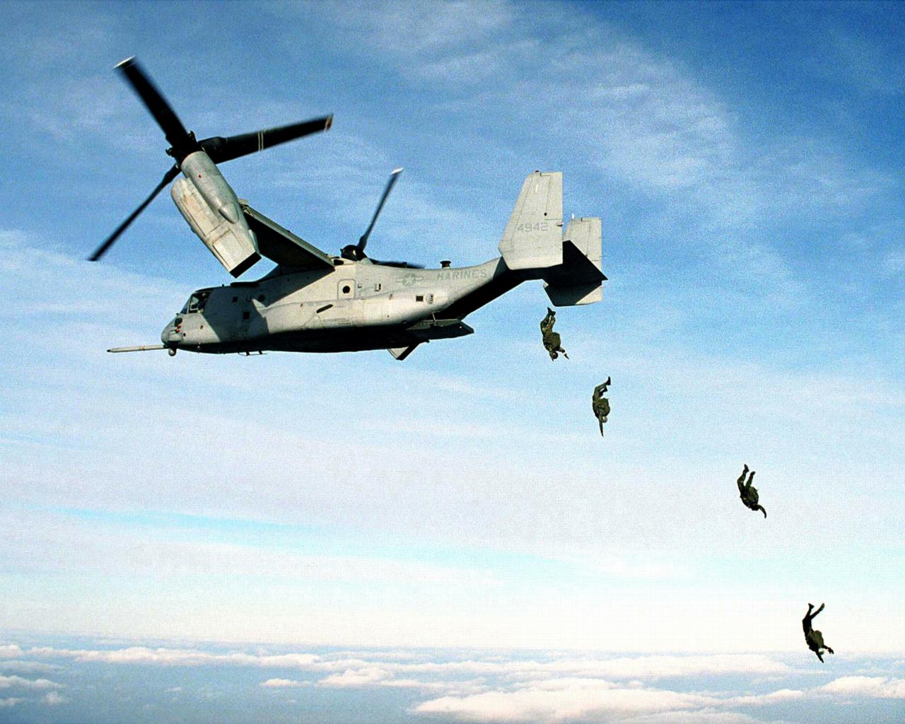 U.S. Marine Corps parachutists free fall<br />from an MV-22 Osprey at 10,000 feet wallpaper